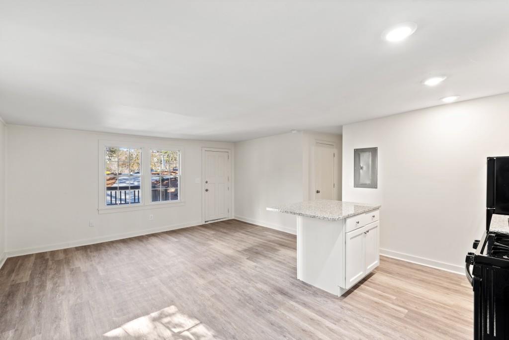 3310 East Roxboro Road Northeast Atlanta, GA 30324 - Photo 38 of 47 a view of an empty room with window and wooden floor