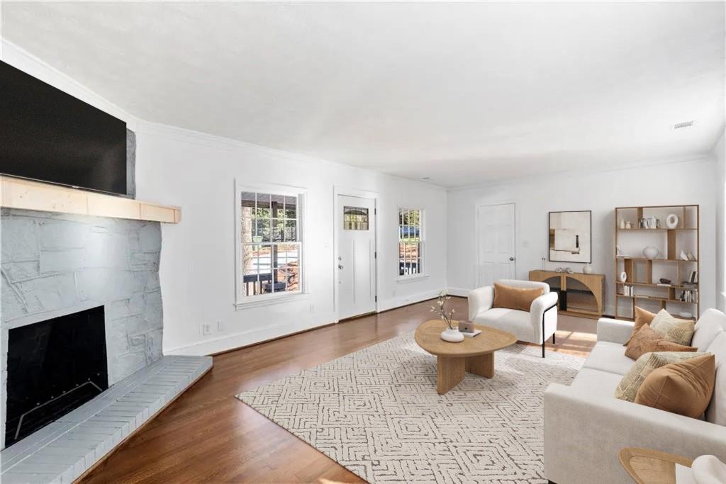 3310 East Roxboro Road Northeast Atlanta, GA 30324 - Photo 7 of 47 a living room with furniture a flat screen tv and a fireplace