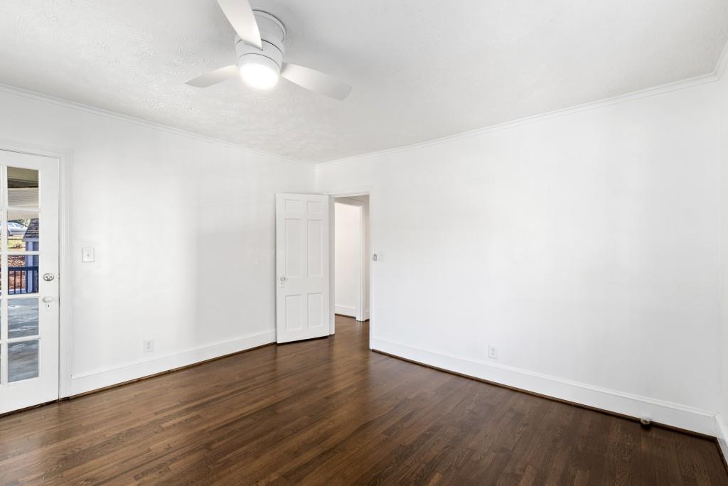 3310 East Roxboro Road Northeast Atlanta, GA 30324 - Photo 9 of 47 an empty room with wooden floor and fan