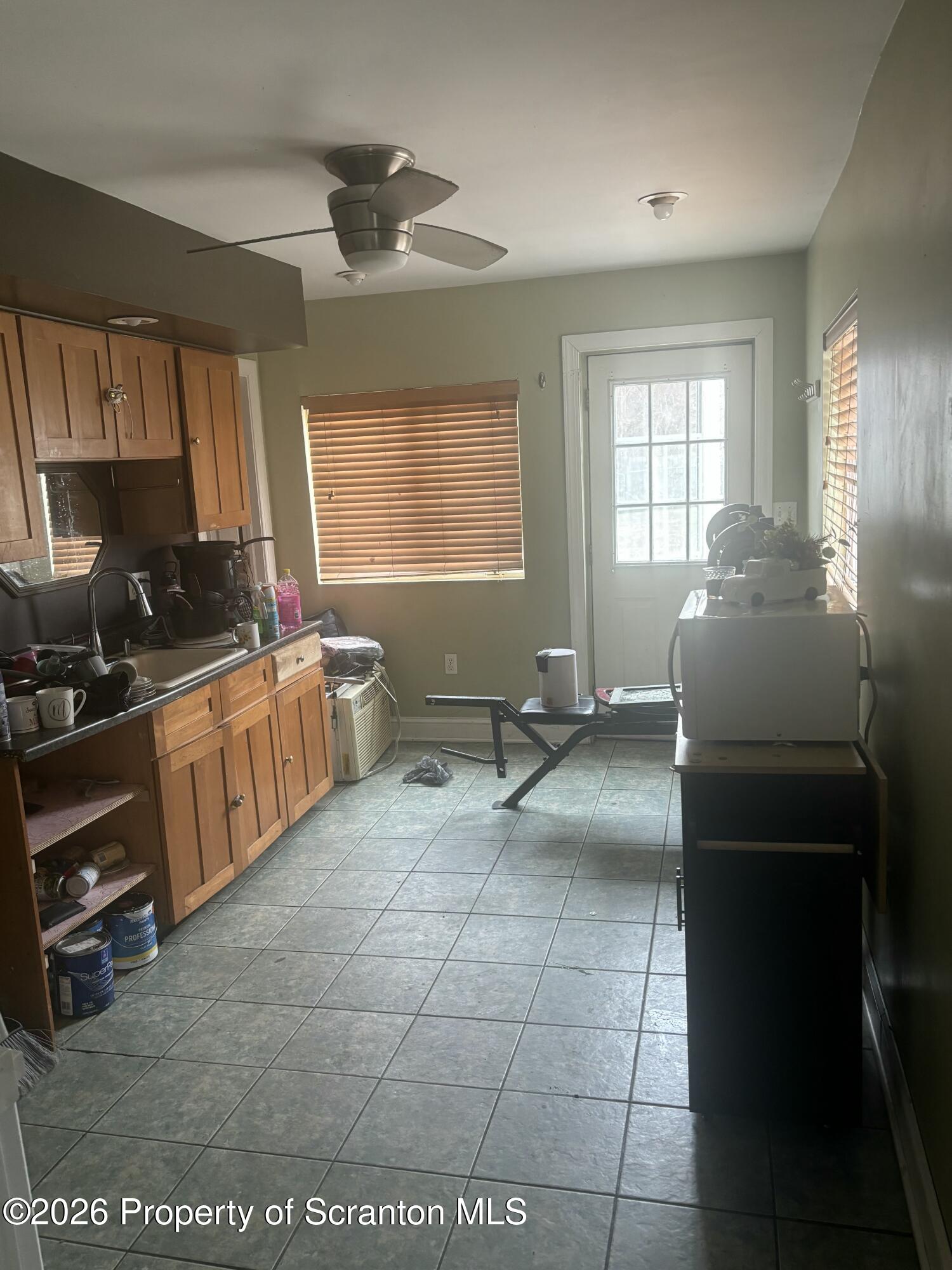 818 Capouse Avenue Scranton, PA 18509 - Photo 7 of 10 a room with a bed furniture and a window