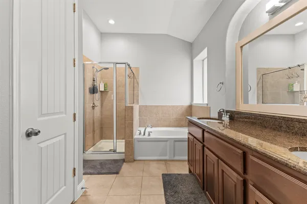 a bathroom with a granite countertop sink a toilet and shower