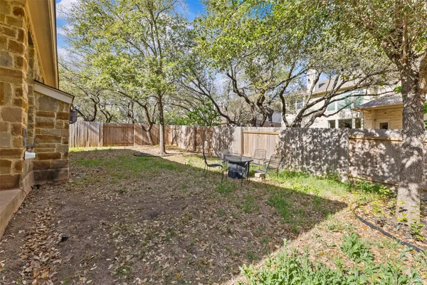 a view of a yard with a house and a tree