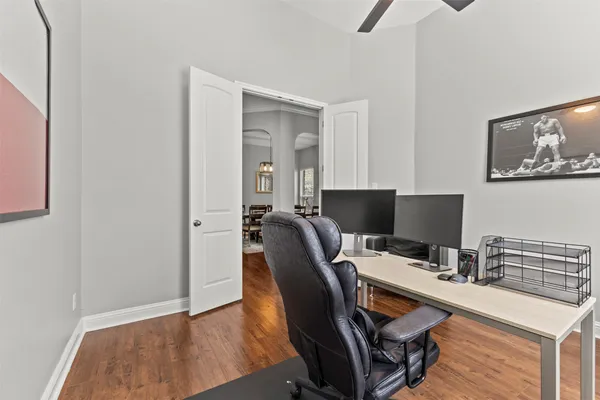a view of a workspace with furniture and wooden floor