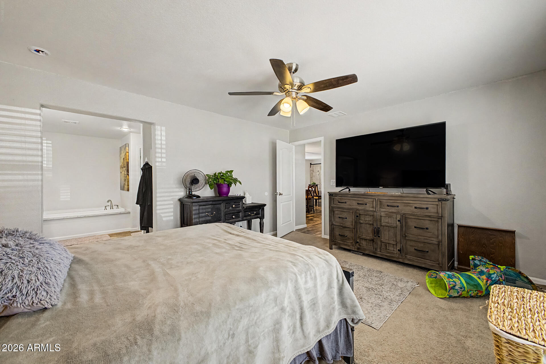 22417 West Dove Valley Road Wittmann, AZ 85361 - Photo 18 of 53 a bedroom with a bed and a flat screen tv