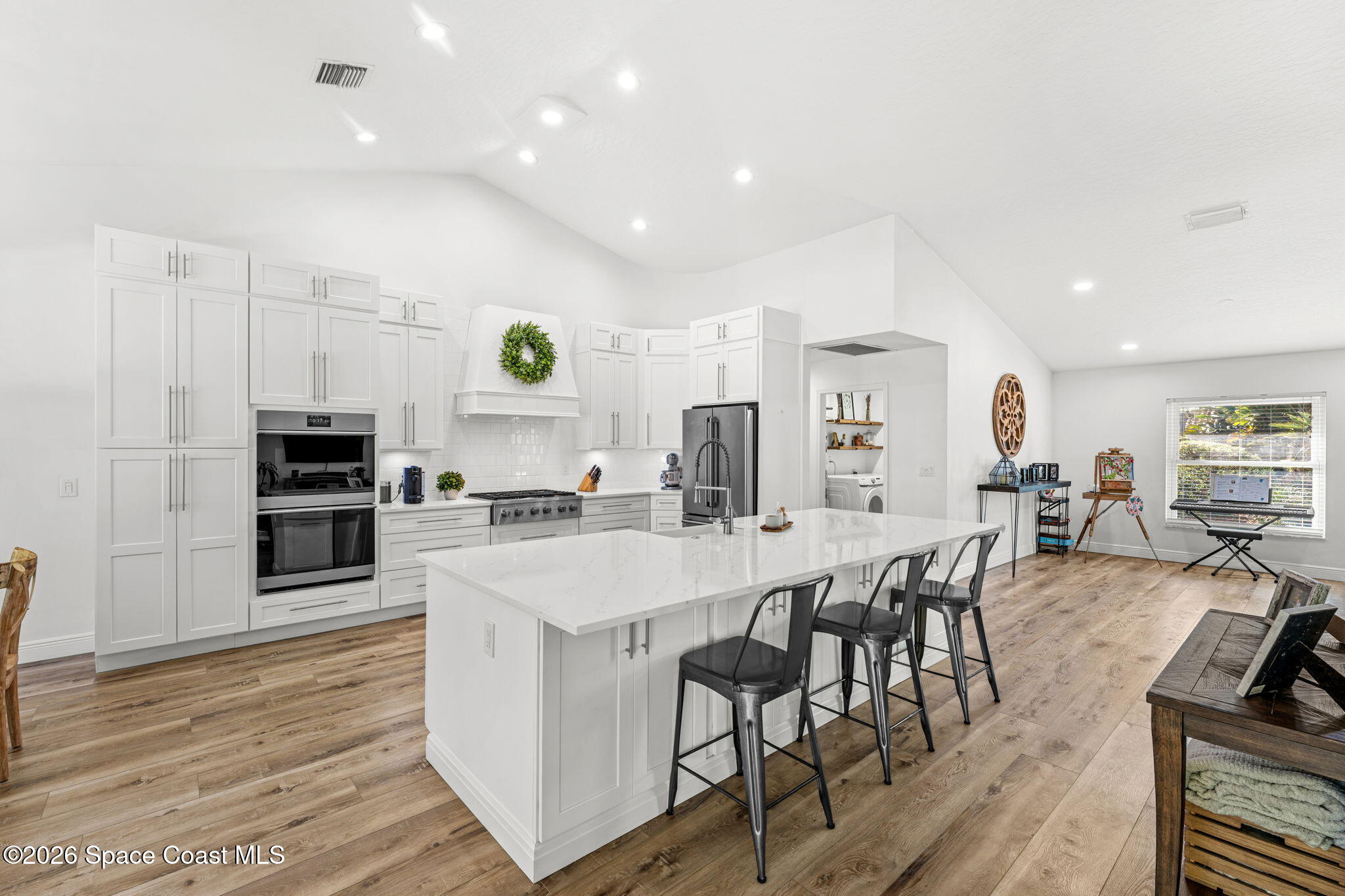 482 Veracruz Boulevard Indialantic, FL 32903 - Photo 11 of 45 a large kitchen with a table and chairs in it