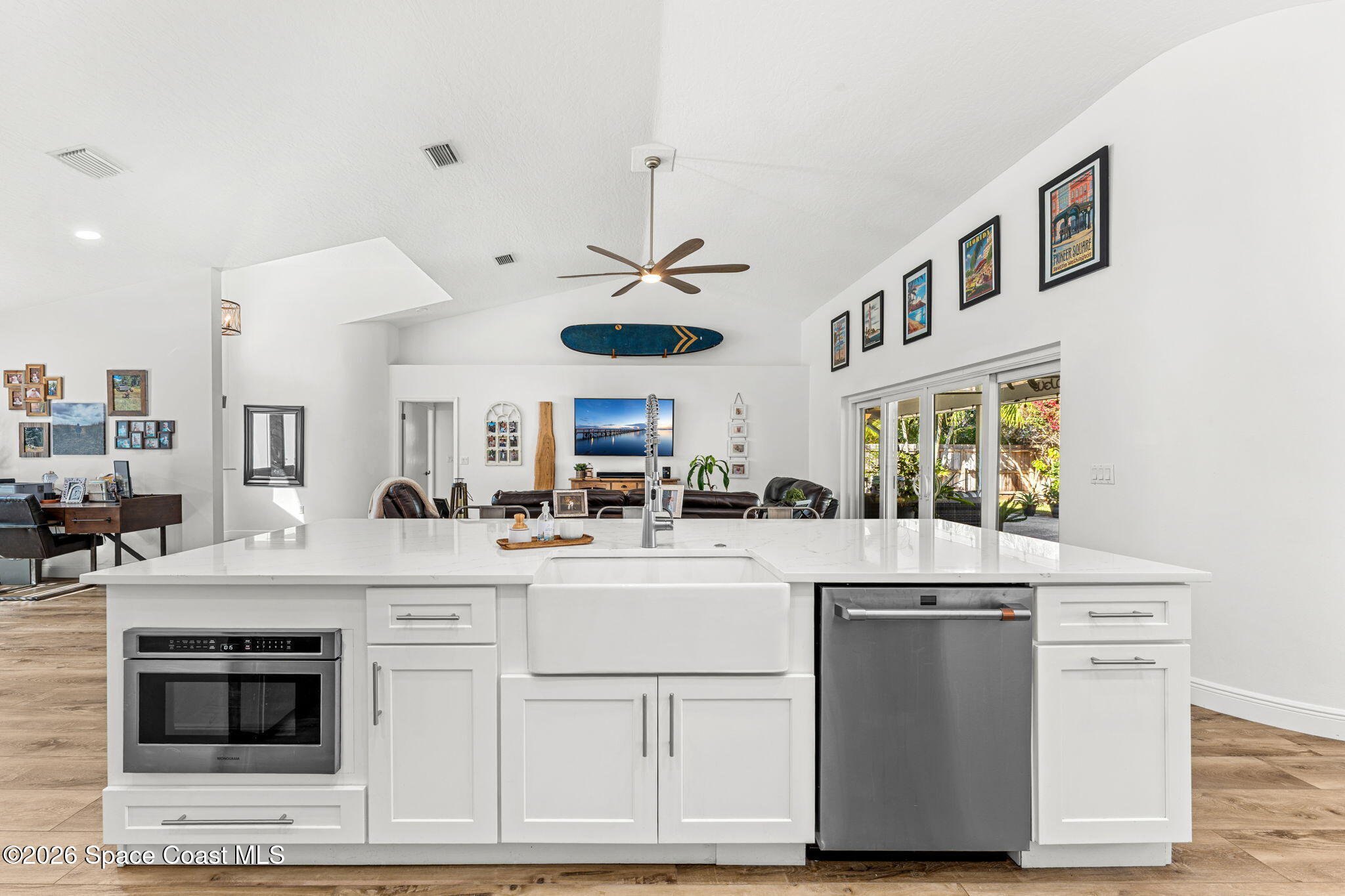 482 Veracruz Boulevard Indialantic, FL 32903 - Photo 13 of 45 a kitchen with kitchen island white cabinets and white appliances