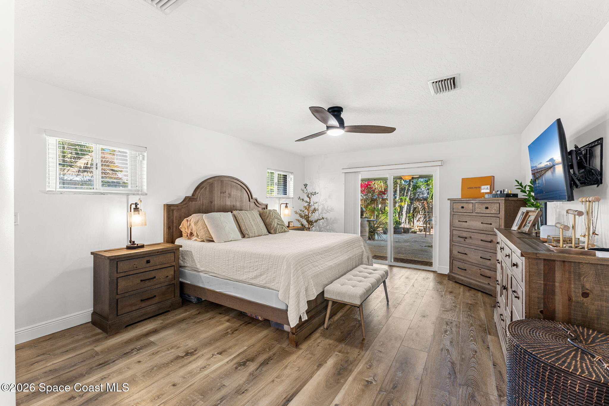 482 Veracruz Boulevard Indialantic, FL 32903 - Photo 18 of 45 a bedroom with a bed and wooden floor