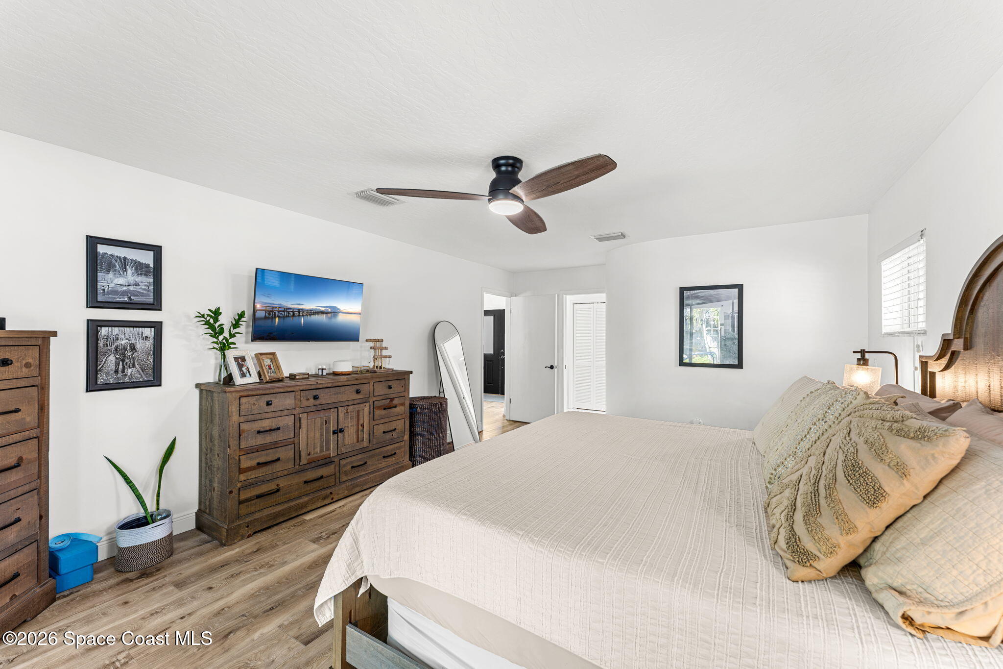482 Veracruz Boulevard Indialantic, FL 32903 - Photo 19 of 45 a bedroom with a bed and a flat screen tv
