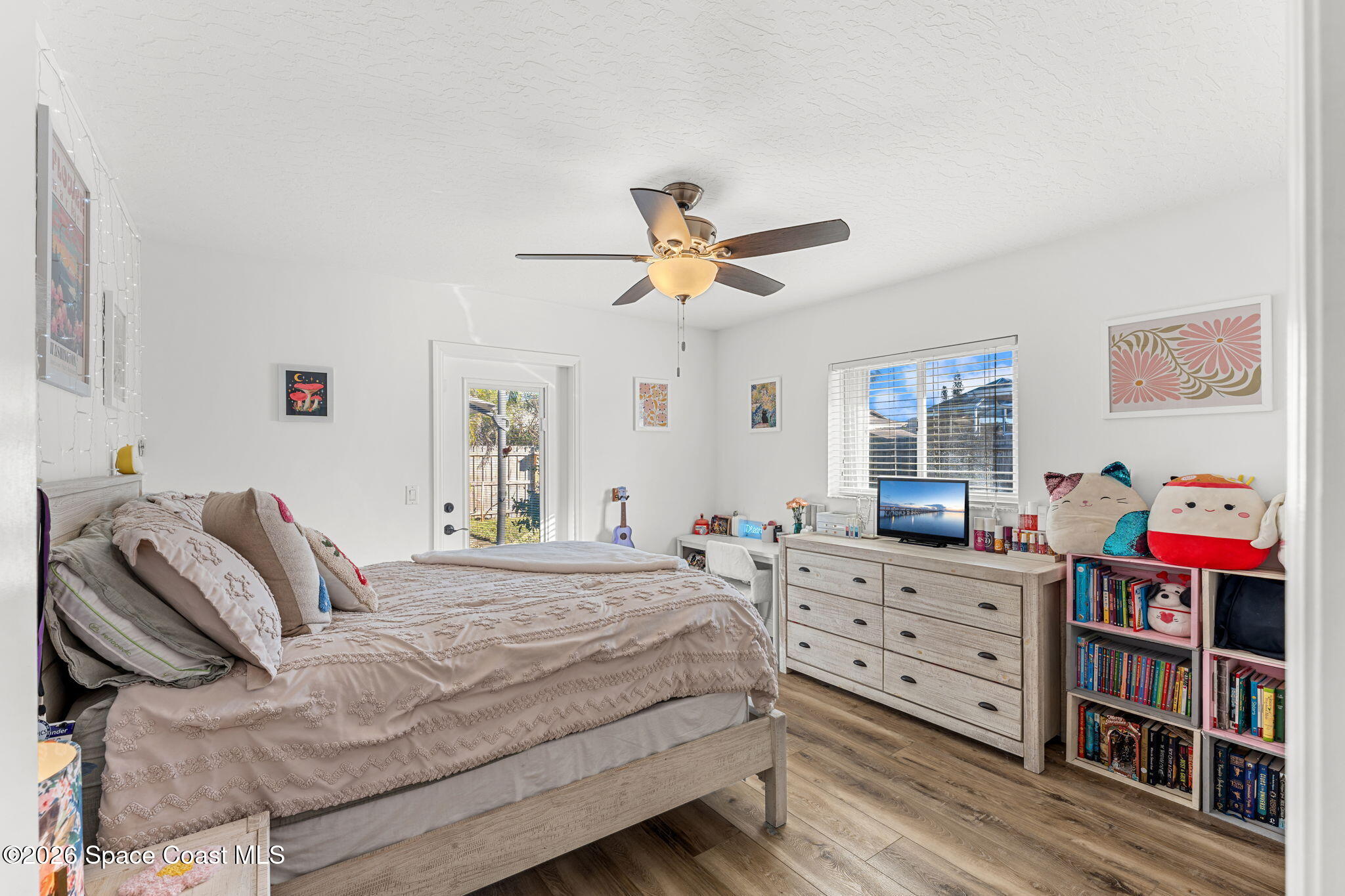 482 Veracruz Boulevard Indialantic, FL 32903 - Photo 23 of 45 a bedroom with a bed dresser and a book shelf