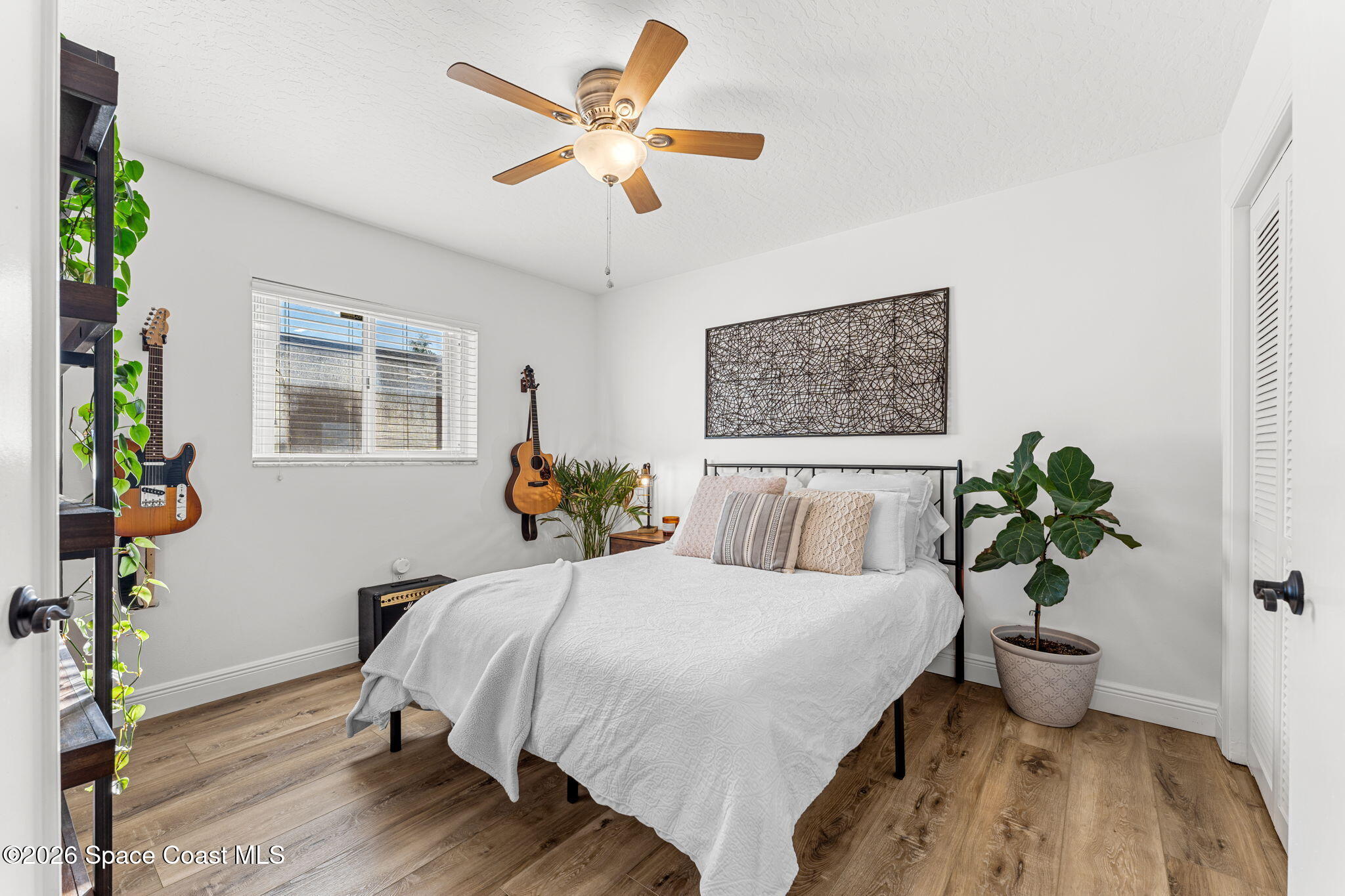 482 Veracruz Boulevard Indialantic, FL 32903 - Photo 25 of 45 a bedroom with a bed and a potted plant