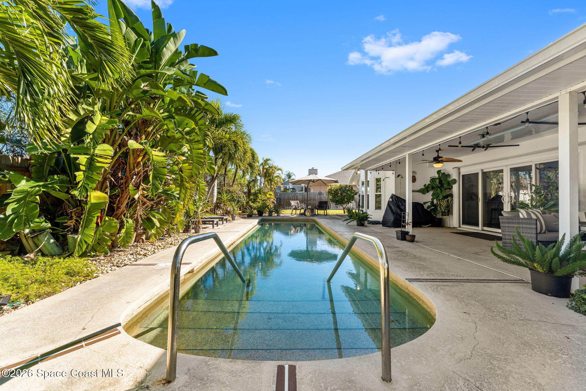 482 Veracruz Boulevard Indialantic, FL 32903 - Photo 30 of 45 a swimming pool with outdoor seating and plants