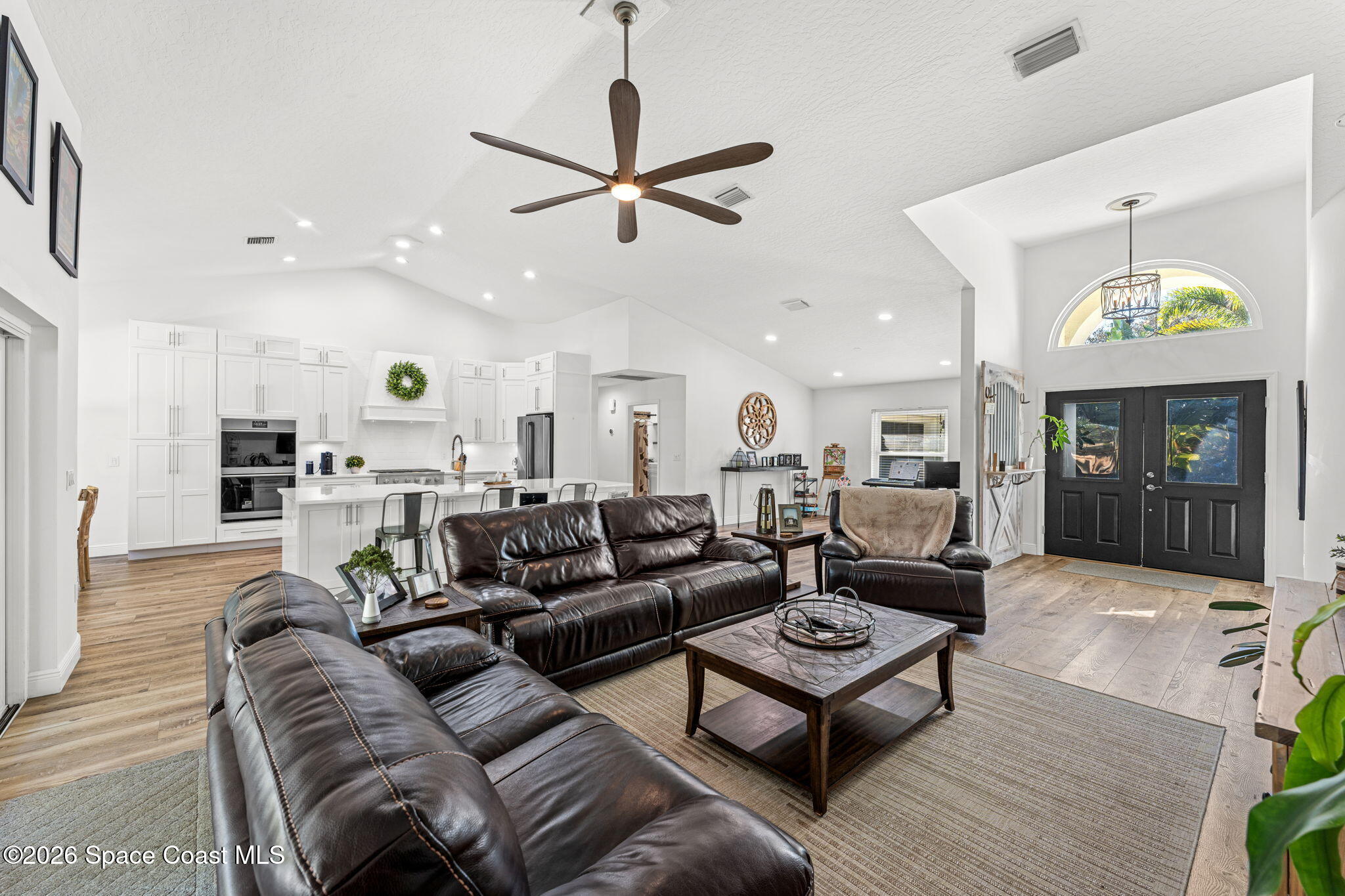 482 Veracruz Boulevard Indialantic, FL 32903 - Photo 7 of 45 a living room with furniture and a chandelier