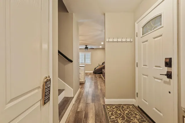 a view of hallway with wooden floor