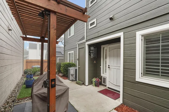 a balcony with furniture and potted plants
