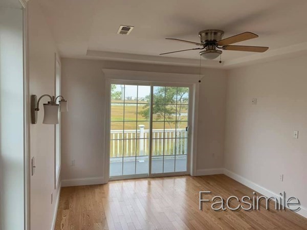 40 Lafayette Road, Unit 2 Salisbury, MA 01952 - Photo 21 of 31 an empty room with wooden floor fan and windows