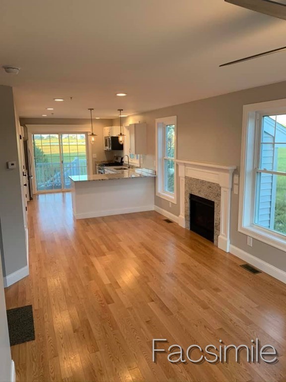 40 Lafayette Road, Unit 2 Salisbury, MA 01952 - Photo 3 of 31 a view of empty room with kitchen and fireplace