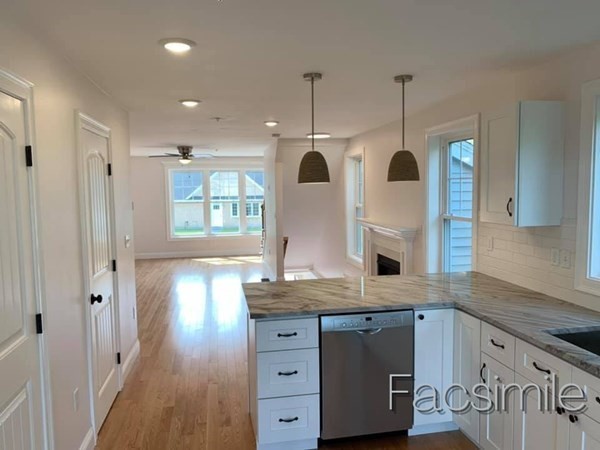 40 Lafayette Road, Unit 2 Salisbury, MA 01952 - Photo 8 of 31 a kitchen with stainless steel appliances granite countertop a sink a stove and a wooden floor