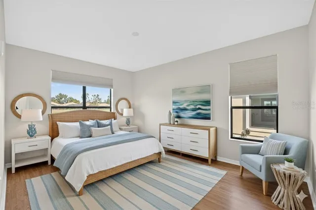 a large kitchen with stainless steel appliances a large counter top a stove and a refrigerator