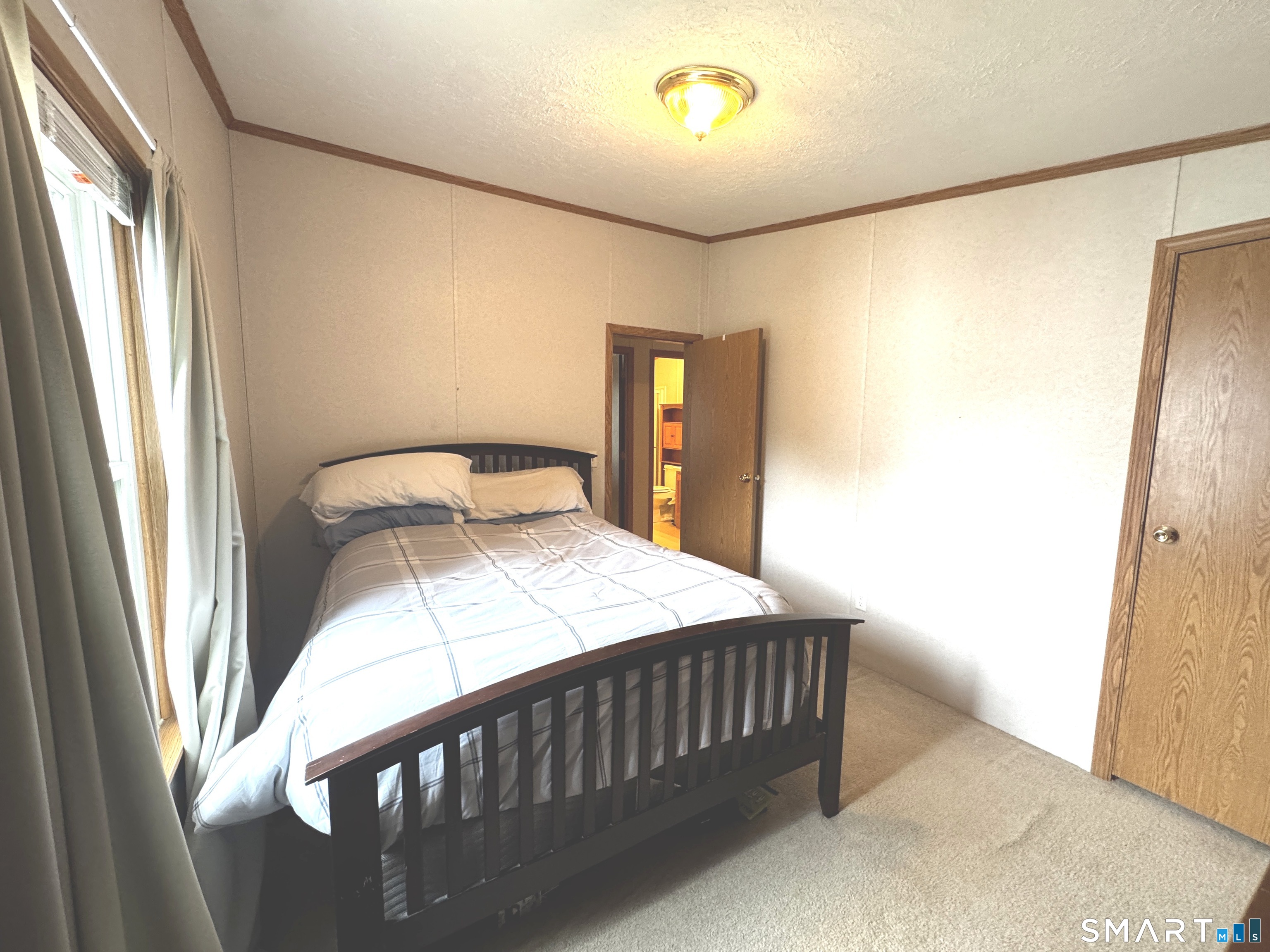 11 Circle Drive Windham, CT 06256 - Photo 11 of 18 a bedroom with a bed and a chandelier