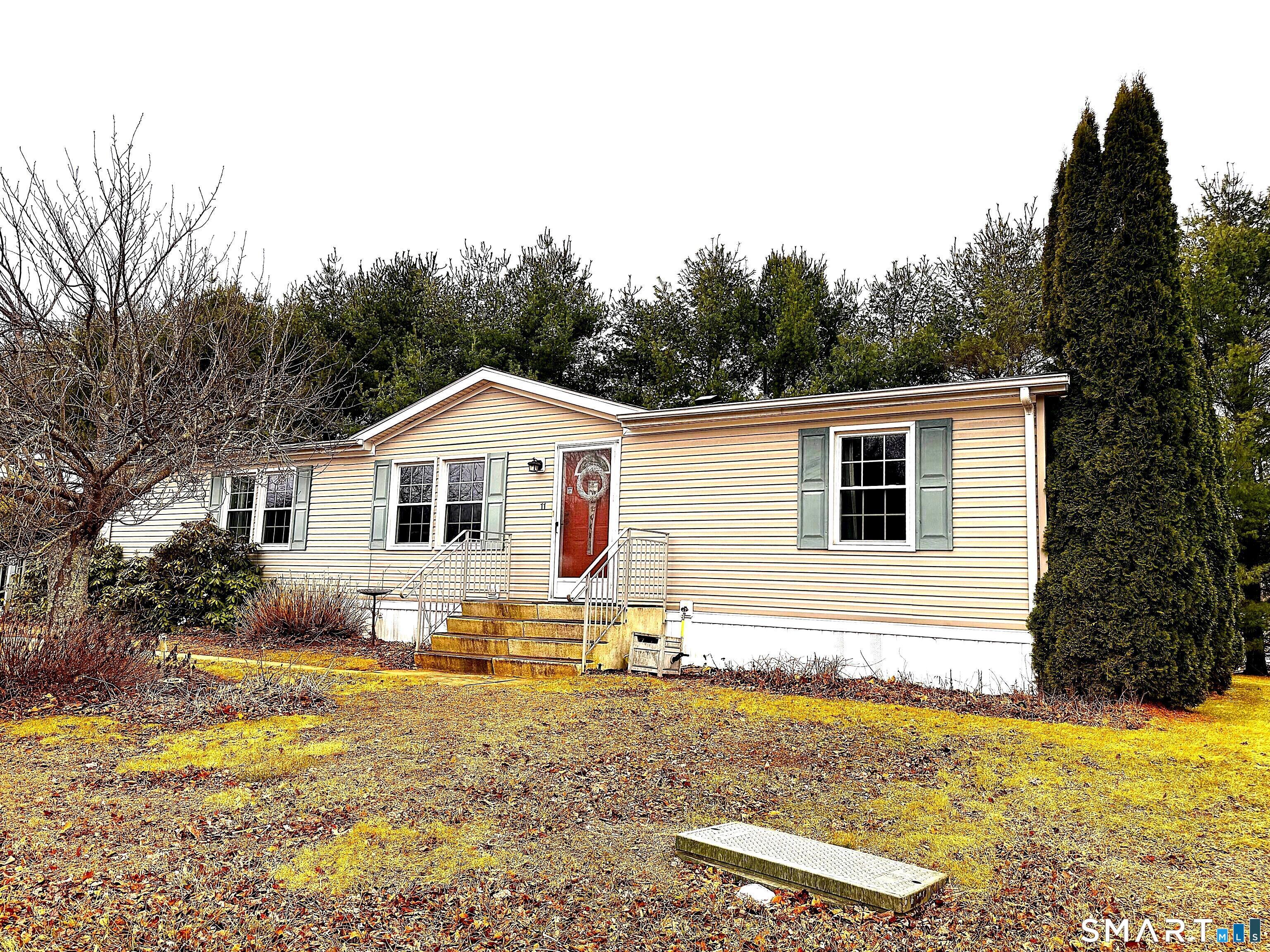 11 Circle Drive Windham, CT 06256 - Photo 2 of 18 a white house that has tree in front of it