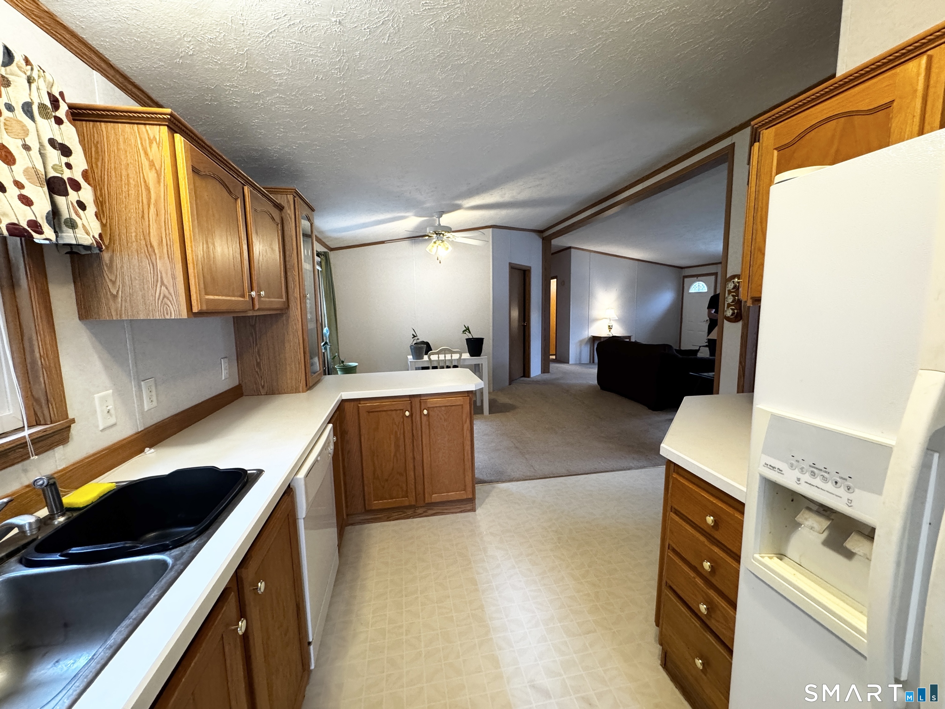 11 Circle Drive Windham, CT 06256 - Photo 3 of 18 a large kitchen with a large window and stainless steel appliances