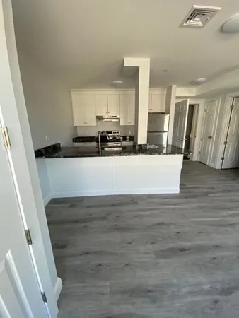 a view of a kitchen cabinets and wooden floor
