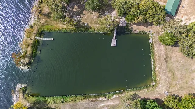 a view of a dining room with furniture and a chandelier fan