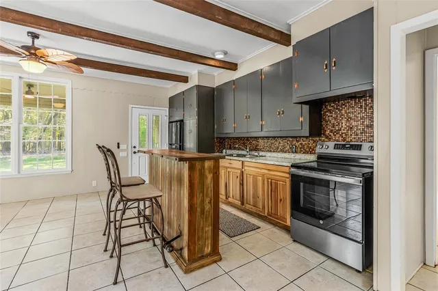 a view of kitchen with furniture and refrigerator