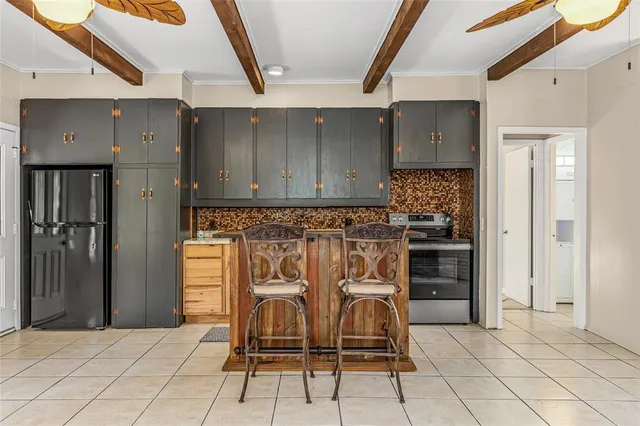 a view of a kitchen with granite countertop stainless steel appliances cabinets and furniture