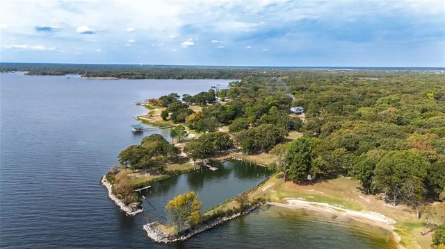 an aerial view of a house with a lake view