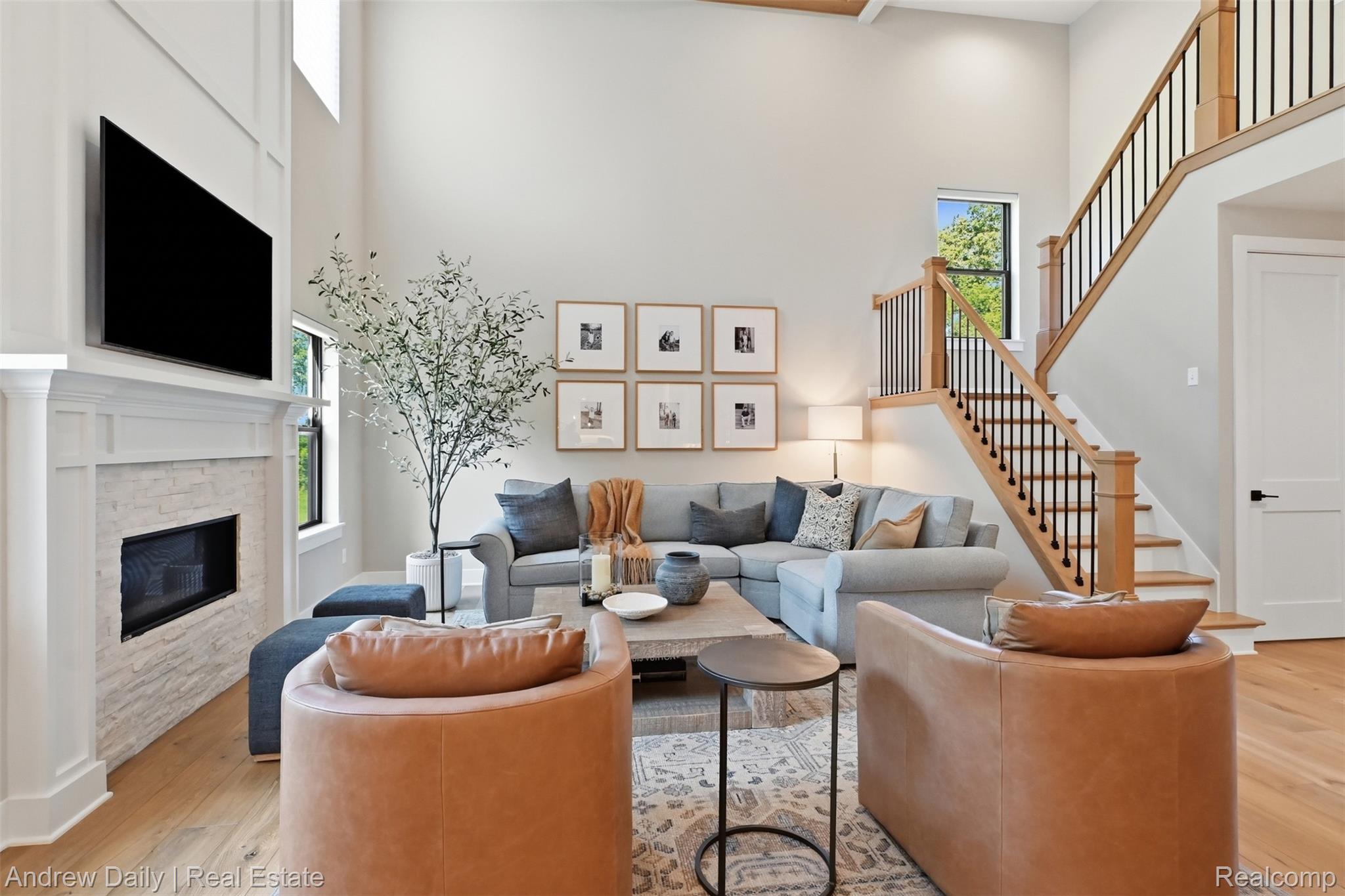 4661 Spears Road Pinckney, MI 48169 - Photo 13 of 56 Spacious living area featuring a two-story ceiling and wood-finish flooring