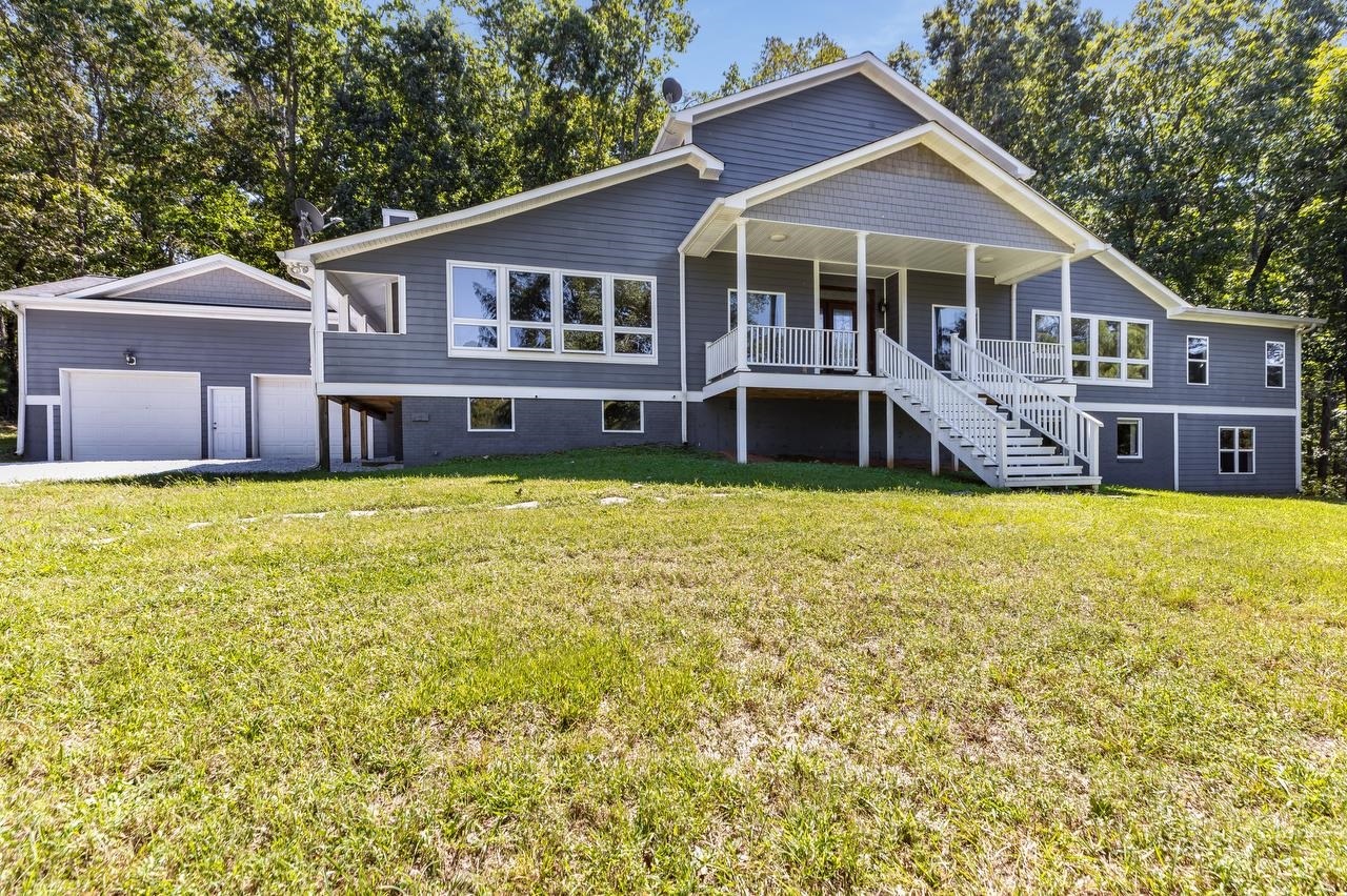 934 Needmore Road Roopville, GA 30170 - Photo 1 of 1 a view of a house with a big yard and large trees