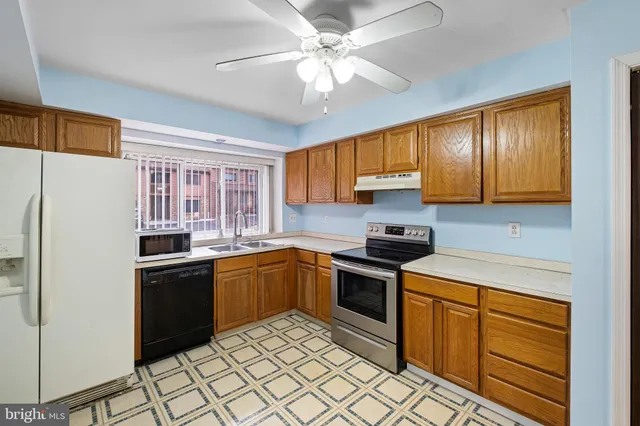 a kitchen with stainless steel appliances granite countertop a stove a sink dishwasher and a refrigerator