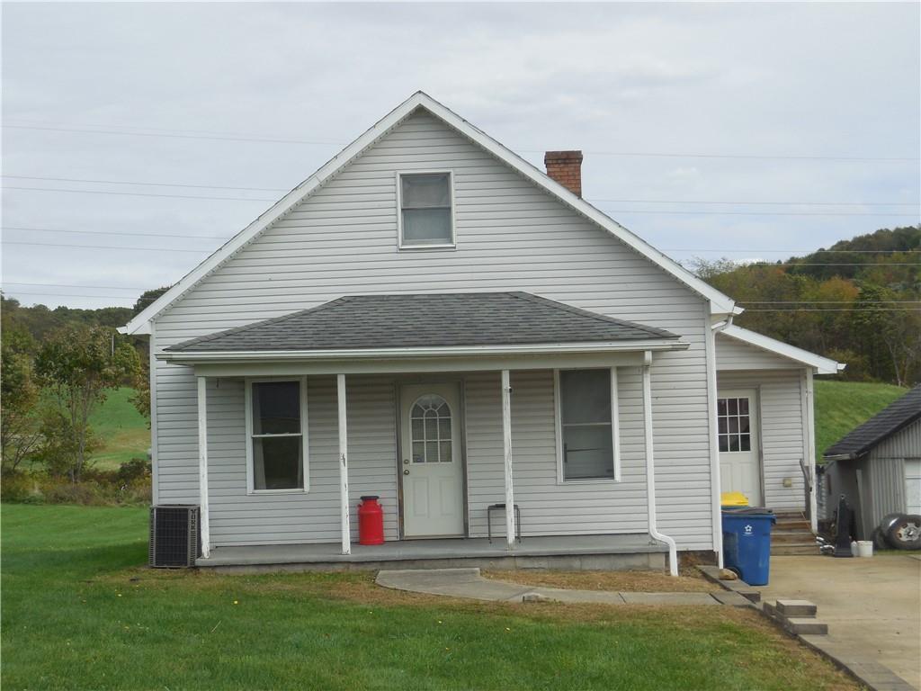 4183 Old Pittsburgh Road Wampum, PA 16157 - Photo 1 of 24 a front view of a house with a garden