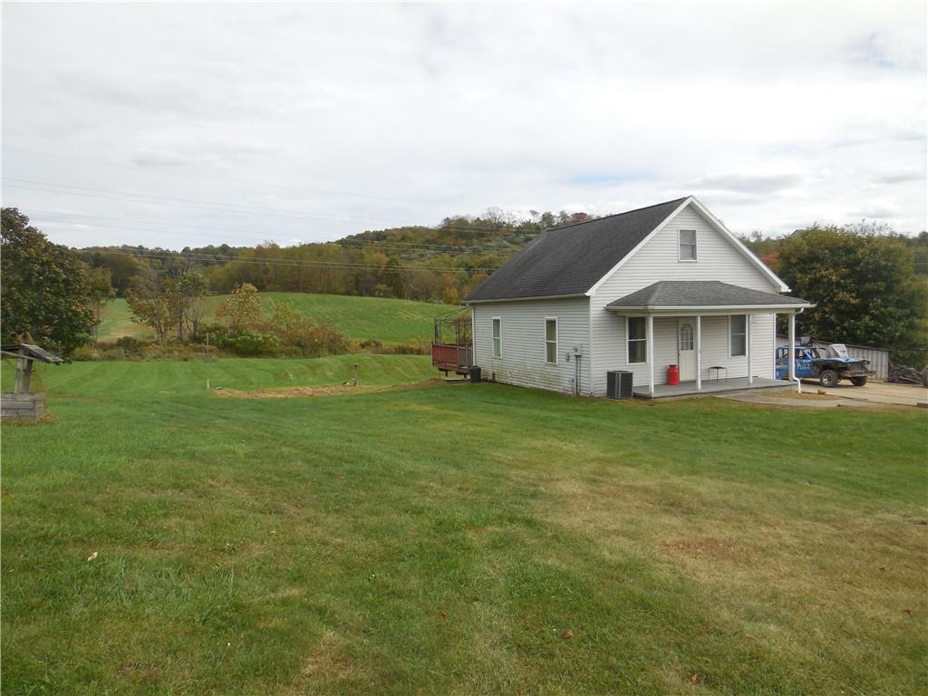 4183 Old Pittsburgh Road Wampum, PA 16157 - Photo 2 of 24 a front view of house with yard and green space