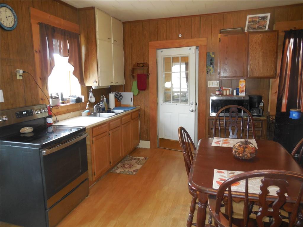 4183 Old Pittsburgh Road Wampum, PA 16157 - Photo 6 of 24 a kitchen with stainless steel appliances kitchen island granite countertop a sink and cabinets
