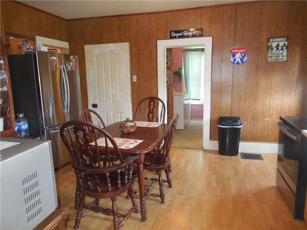 4183 Old Pittsburgh Road Wampum, PA 16157 - Photo 7 of 24 a view of a dining room with furniture and a chandelier