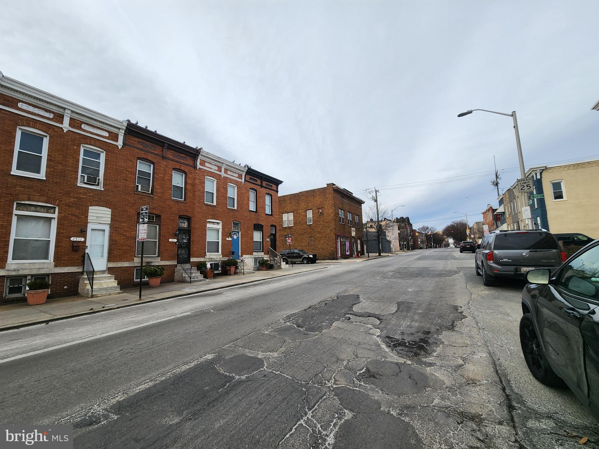 2514 East Madison Street Baltimore, MD 21205 - Photo 3 of 3 a city street lined with parked cars and buildings