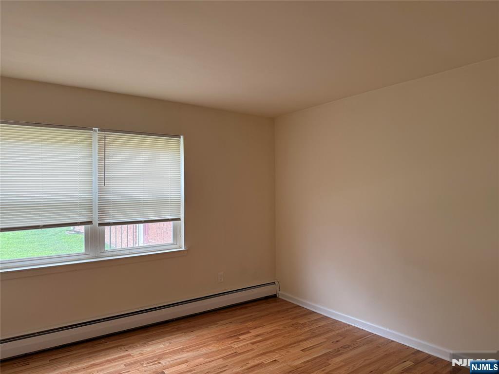 2 Rustic Circle, Unit A Montvale, NJ 07645 - Photo 5 of 8 a view of an empty room with wooden floor and a window