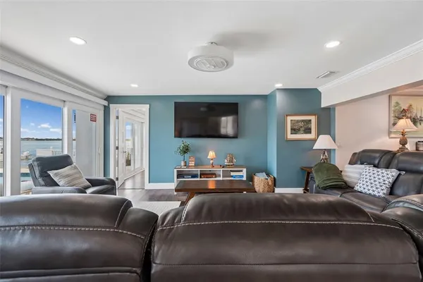 a living room with furniture and a floor to ceiling window