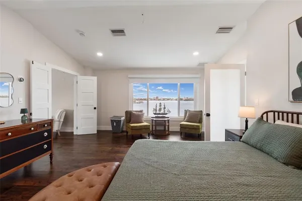 a view of a dining room and livingroom with furniture wooden floor a chandelier