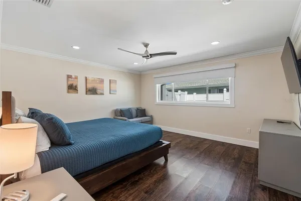 a room with a bed and a view of kitchen