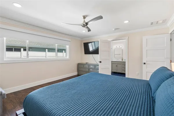 a bedroom with a large bed and a window