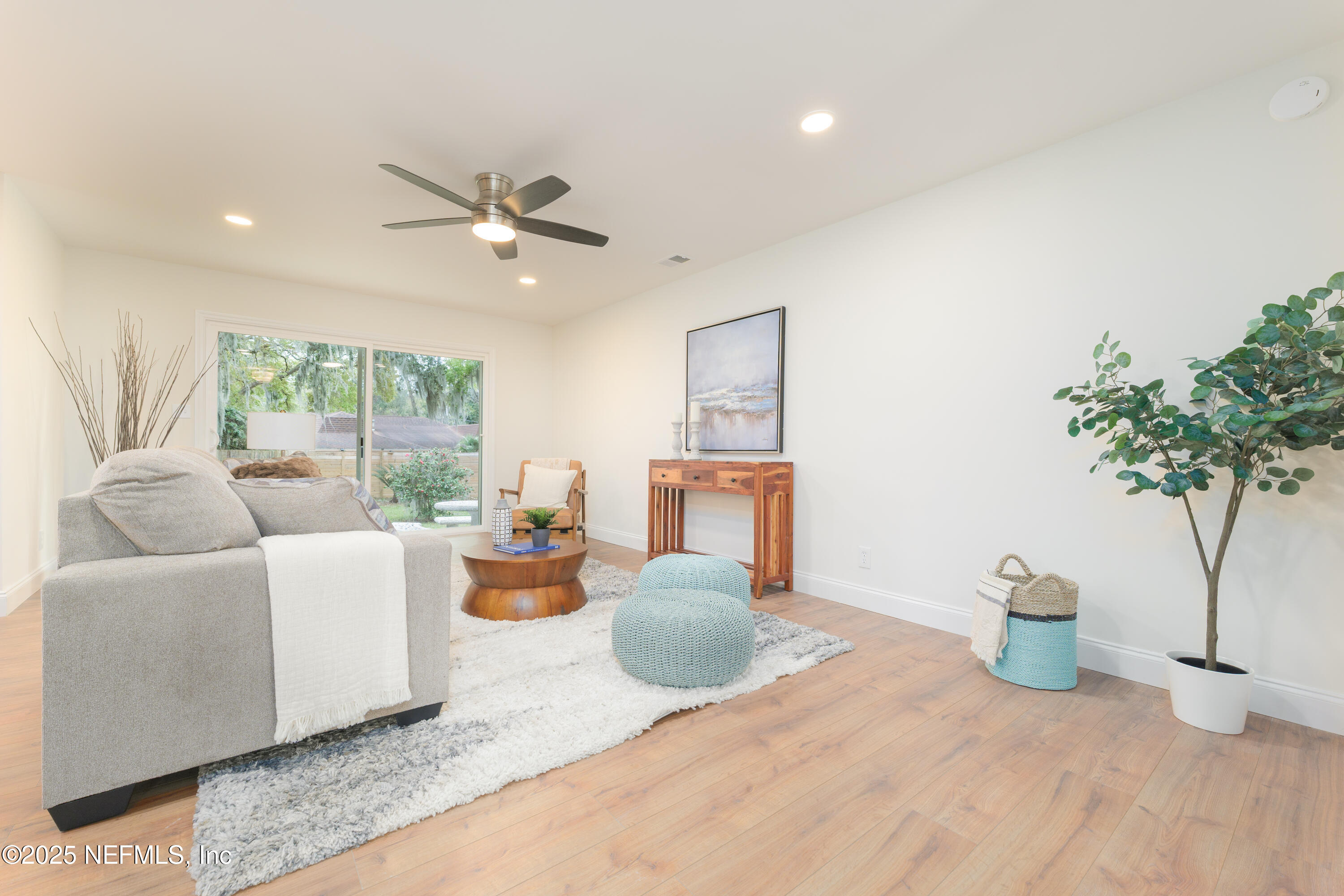 4146 Heath Road Jacksonville, FL 32277 - Photo 4 of 36 a living room with furniture a potted plant and a large window