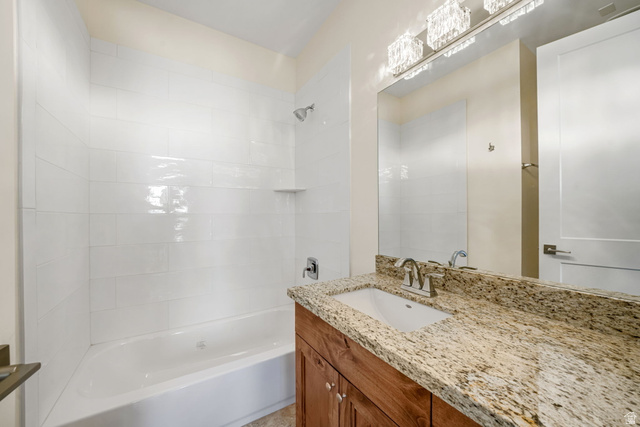 1238 Canyon View Road Midway, UT 84049 - Photo 15 of 33 Spa-inspired master bathroom featuring a granite countertop with an undermount sink, oil-rubbed bronze faucet fixtures, and rich wood cabinetry