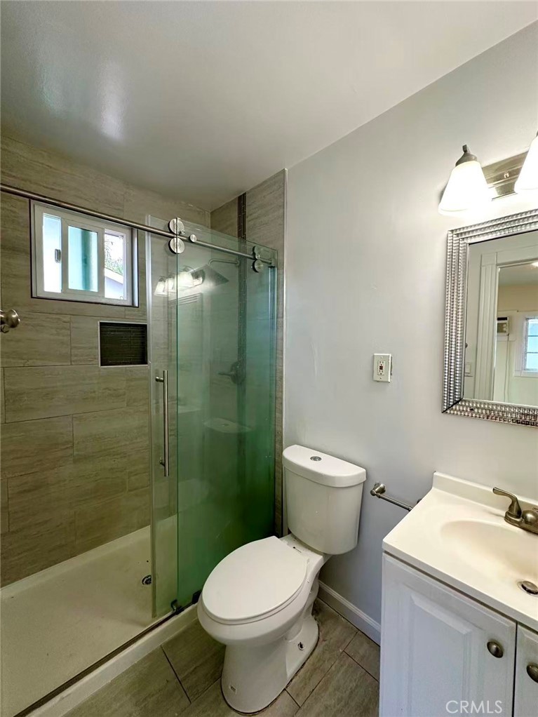 1143 South 9th Avenue Hacienda Heights, CA 91745 - Photo 11 of 15 a bathroom with a granite countertop toilet a sink and shower