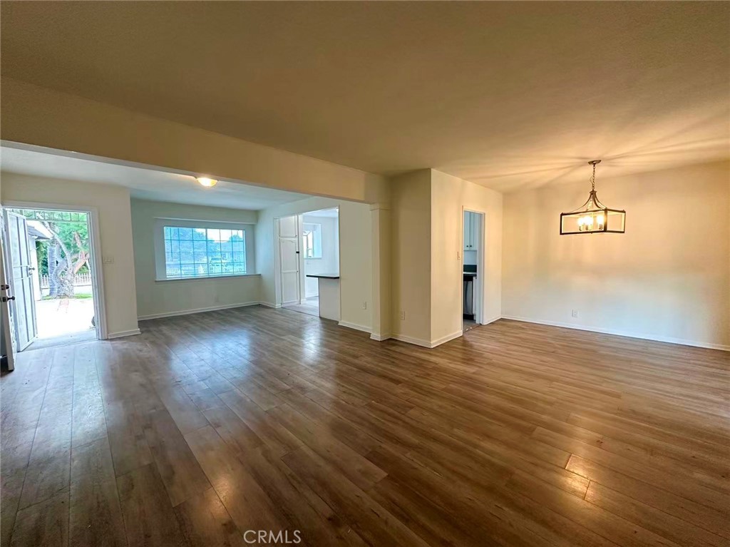 1143 South 9th Avenue Hacienda Heights, CA 91745 - Photo 5 of 15 an empty room with wooden floor and windows