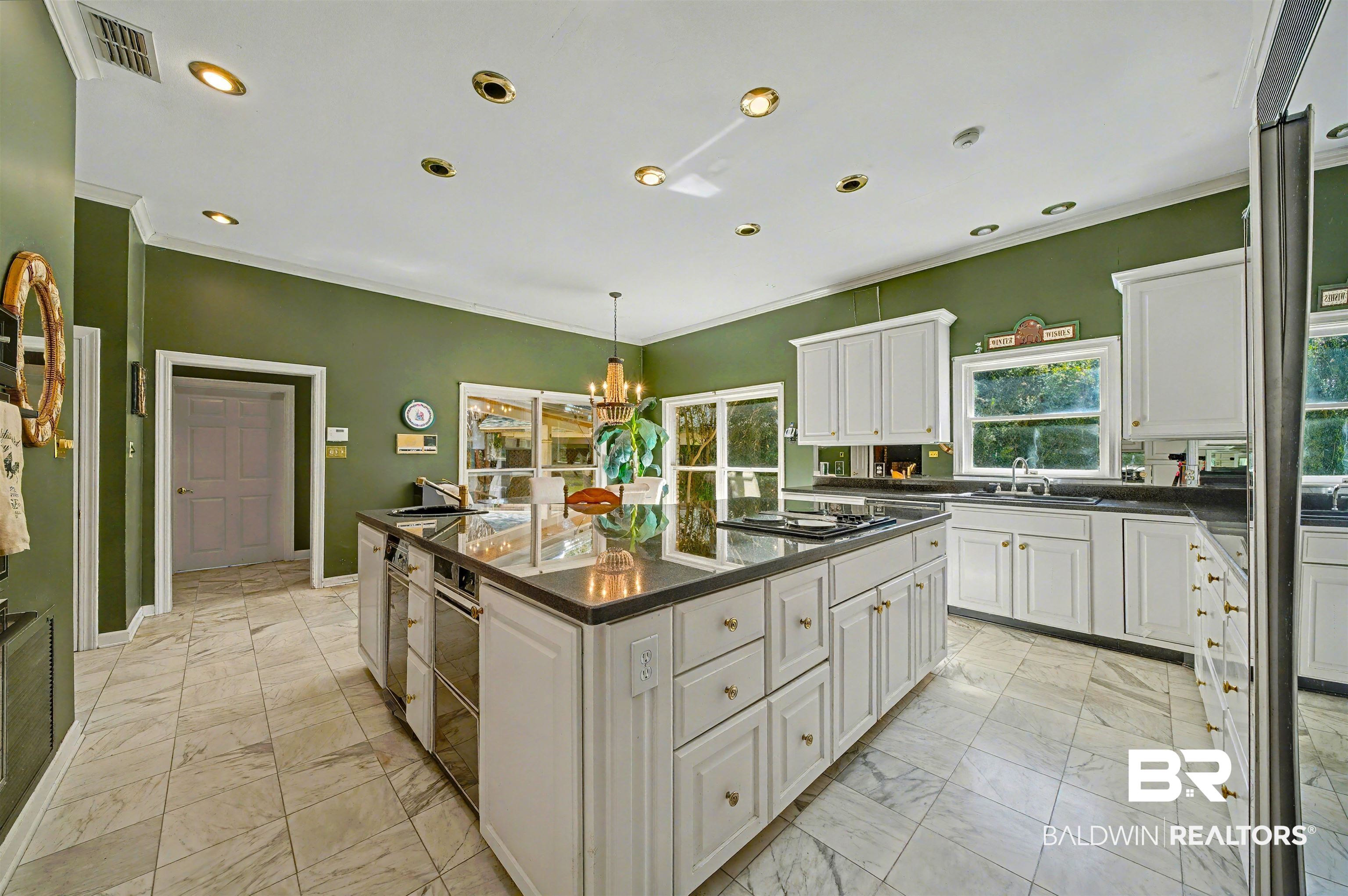 15810 County Road 73 Foley, AL 36535 - Photo 20 of 56 Kitchen featuring crown molding, light marble finish floors, white cabinetry, decorative light fixtures, and a kitchen island