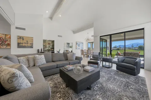 a living room with furniture couches and a large window
