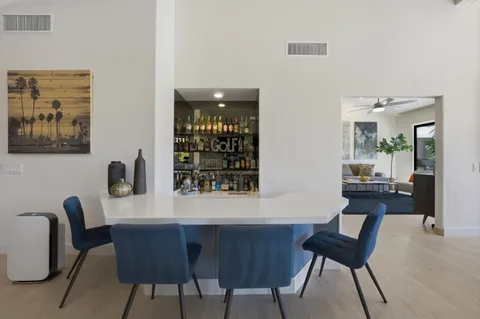 a dining room with furniture and window